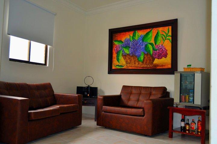 Casa Morales Hotel Internacional Y Centro De Convenciones Ibagué Exteriér fotografie A living room with a sofa and armchair